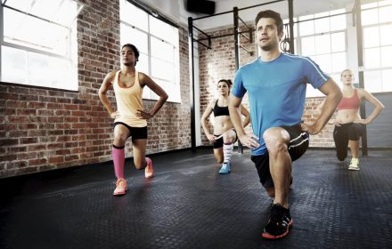 Shot of a diverse group of individuals doing lunges in a gym